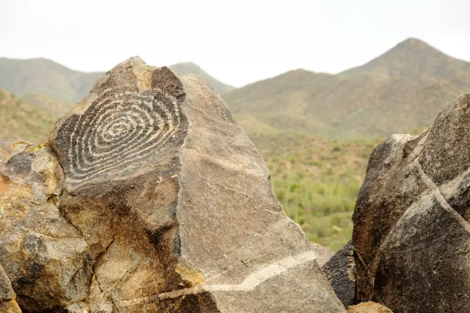 A spiral petroglyph adorns a rock in the desert of Arizona.